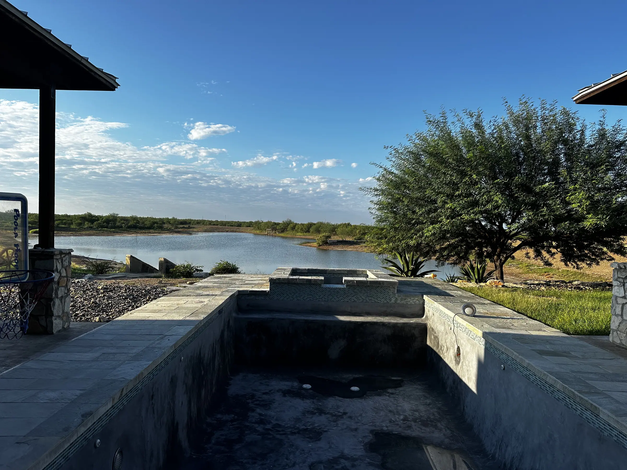 New infinity-edge pool under construction on a lot overlooking a lake outside Laredo